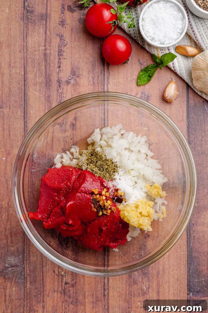 The microwave-prepped sauce ingredients mixed together in a glass bowl, creating a rich base for the Slow Cooker Chicken Pomodoro.