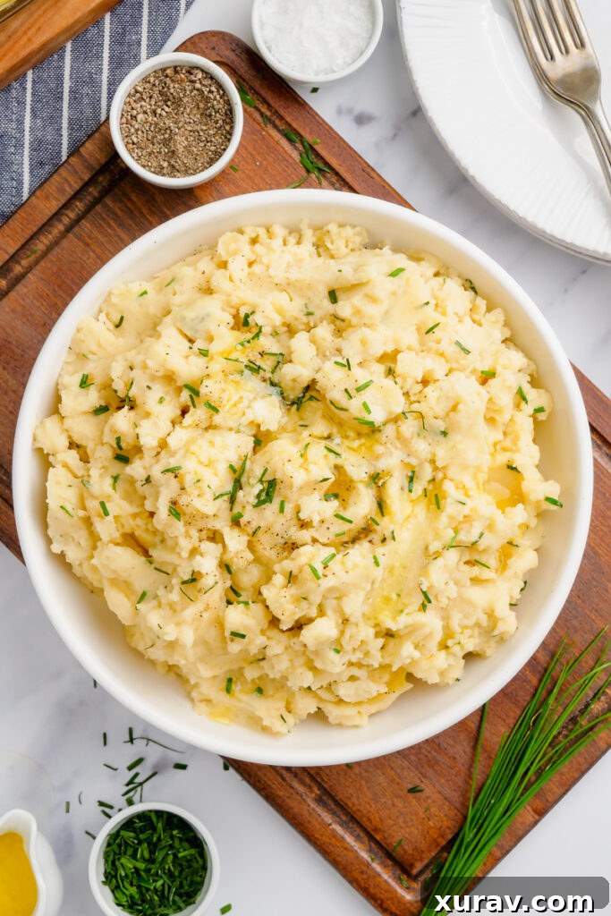 A large serving bowl filled with creamy slow cooker mashed potatoes, ready for a family meal or gathering.
