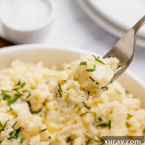 mashed potatoes in a white bowl with a fork