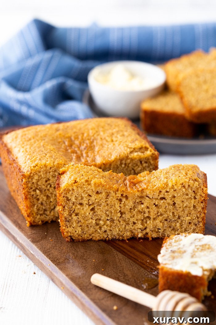 Freshly baked Honey Whole Wheat Banana Bread loaf cooling on a wire rack, showcasing its golden-brown crust and moist interior.