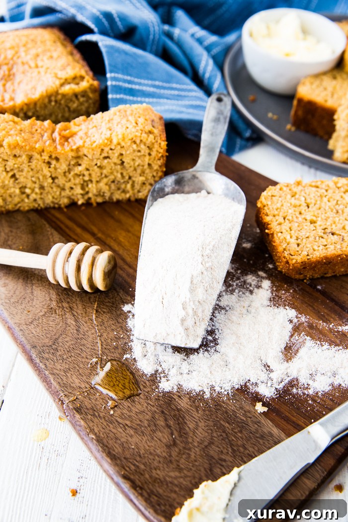 Close-up of a second Honey Whole Wheat Banana Bread loaf, showing the textured crust and a hint of the soft, golden interior.