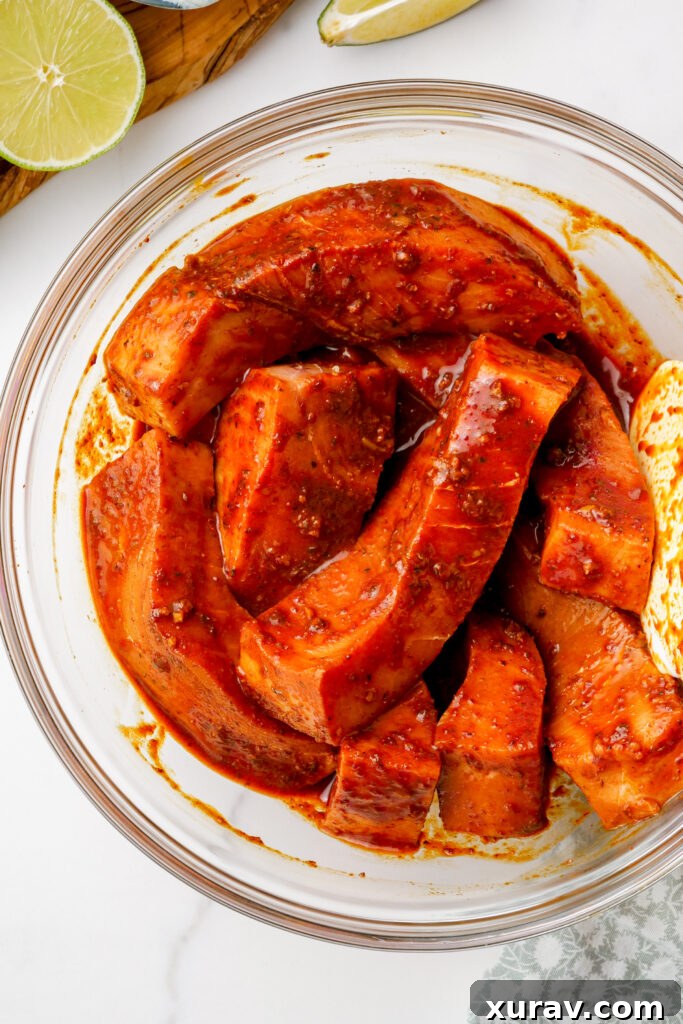A bowl of swordfish coated in marinade, for grilled fish tacos