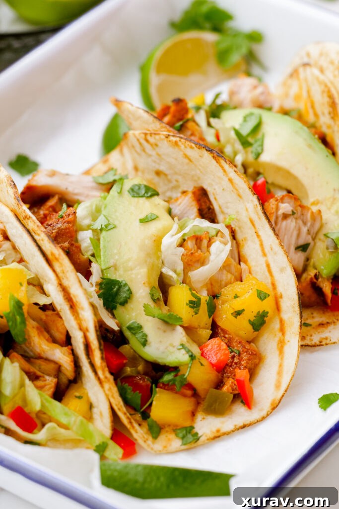 Making grilled fish tacos, assembled into tacos on a white plate
