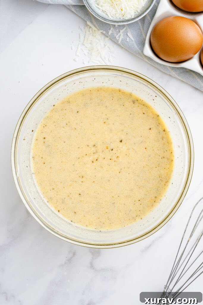 A close-up shot of hands whisking eggs, grated Pecorino Romano cheese, and heavy cream in a bowl, preparing the base for a creamy carbonara sauce.