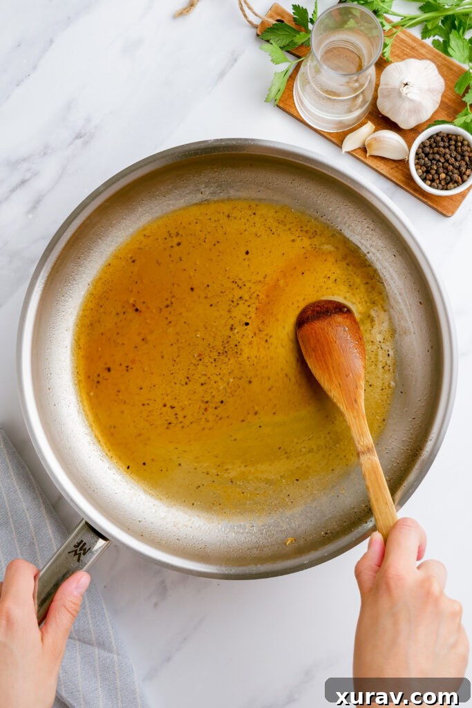 A close-up of spaghetti carbonara being prepared, with wine simmering in a skillet, crucial for deglazing and adding depth to the sauce.