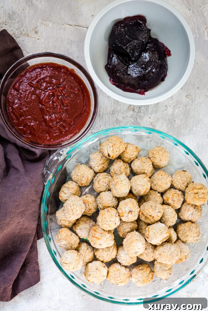 Sticky Sweet Slow Cooker Meatballs 3 Crockpot grape jelly meatballs simmering in a slow cooker, showing their rich, glossy glaze.