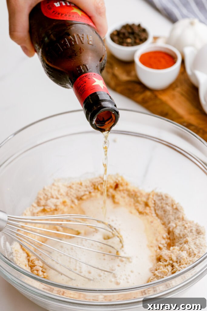 Adding cold beer to the dry ingredients to form the batter