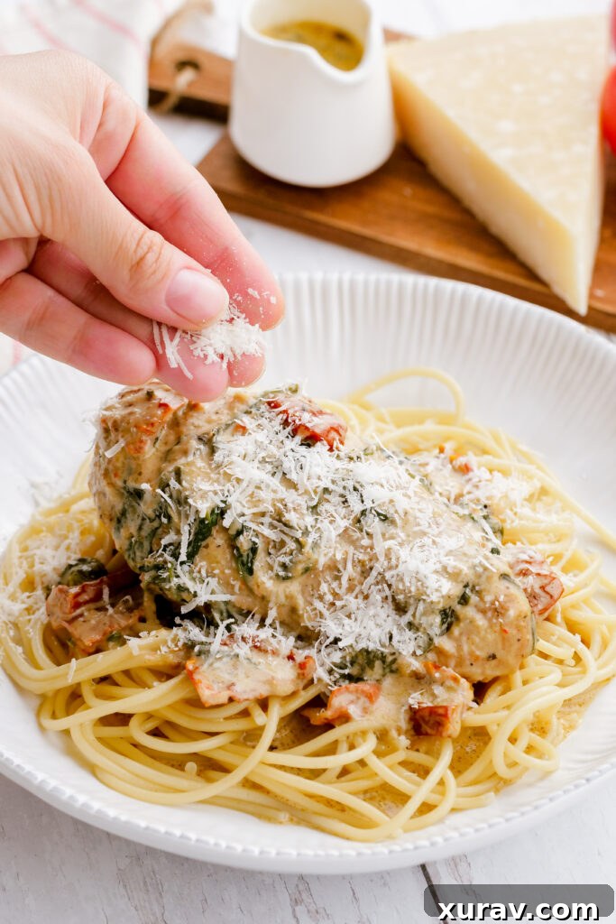 Garnishing tuscan chicken with parmesan cheese