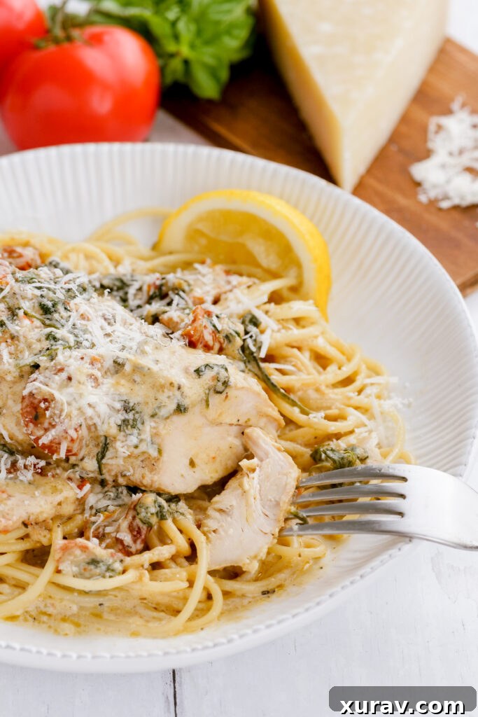 A plate of instant pot pressure cooker tuscan chicken on a bed of pasta