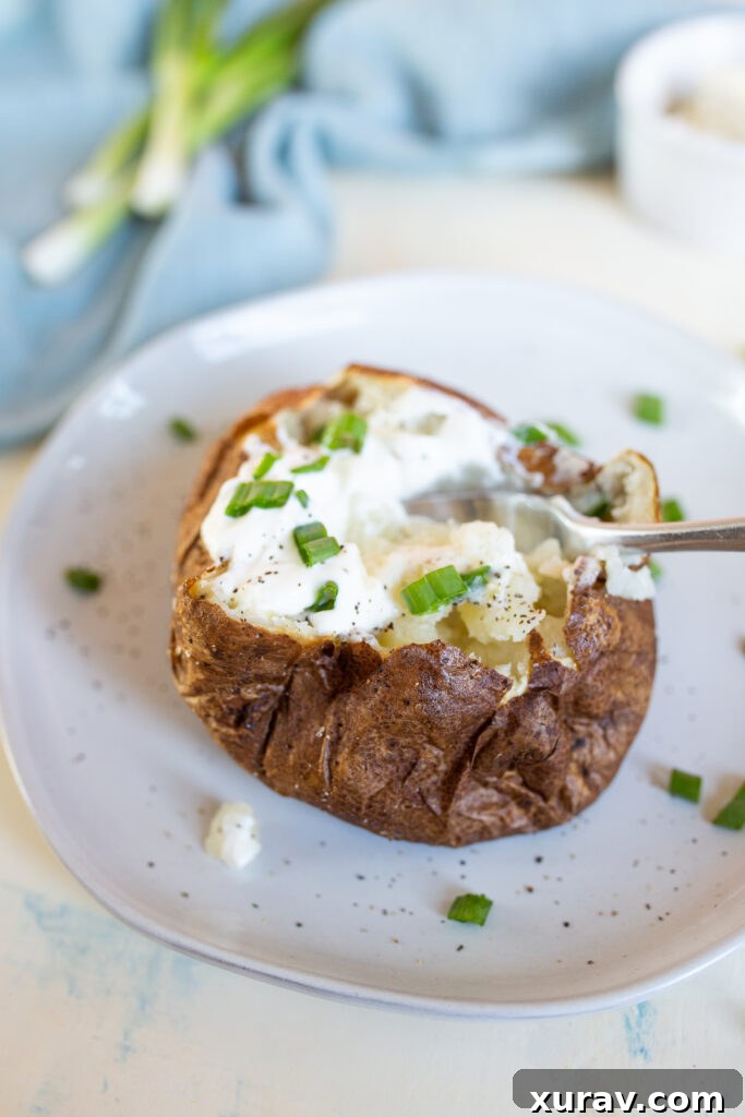 Air fryer baked potatoes with crispy skin and fluffy interior