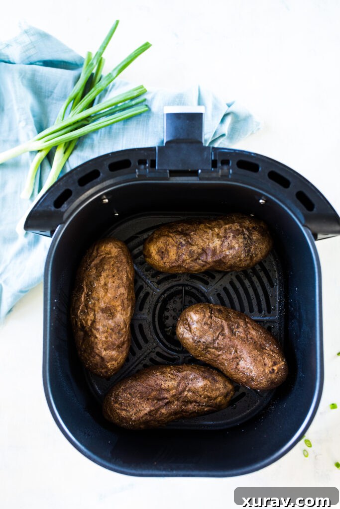 Air fryer baked potatoes are the crispiest skin, fluffiest inside.