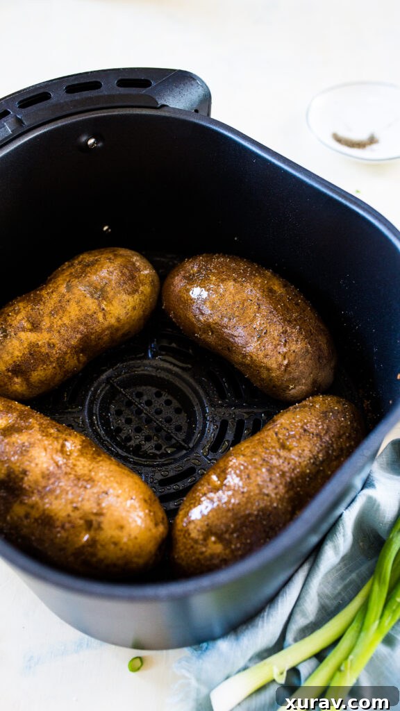 Easy air fryer "baked" potatoes, making crispy skin and fluffy interior baked potatoes in the air fryer.