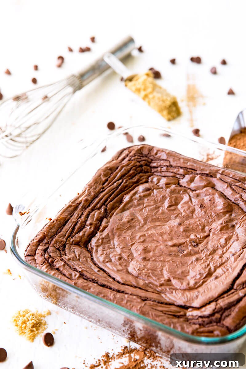 A big old pan of chewy chocolate brownies, ready to be sliced.