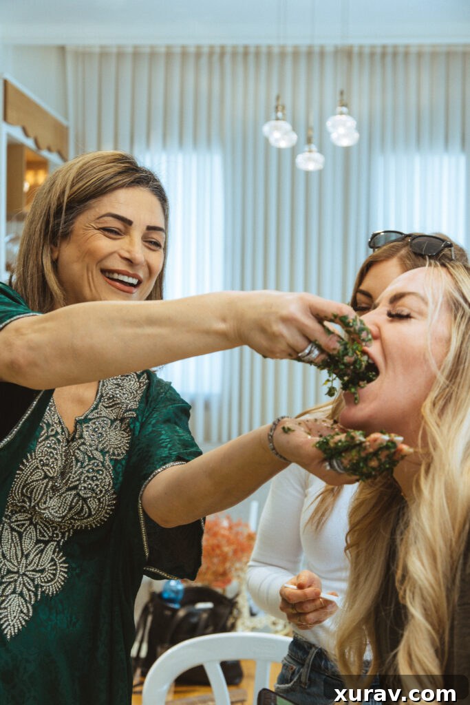 Doris, a local Arab Christian woman from Jaffa, teaching how to prepare Tabbouleh in her kitchen. The image captures the authentic culinary experience.