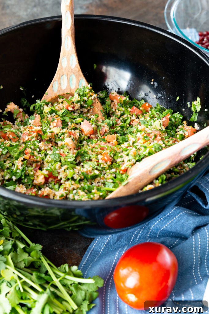 A beautifully presented bowl of Israeli Tabbouleh salad, featuring a generous amount of fresh herbs, tender bulgur, and a bright lemony dressing, ready to be enjoyed.