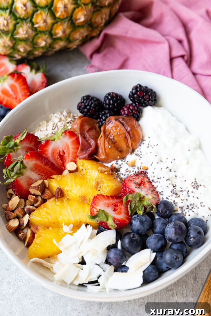 A breakfast bowl made up of high protein cottage cheese and fruits, nuts, seeds. 