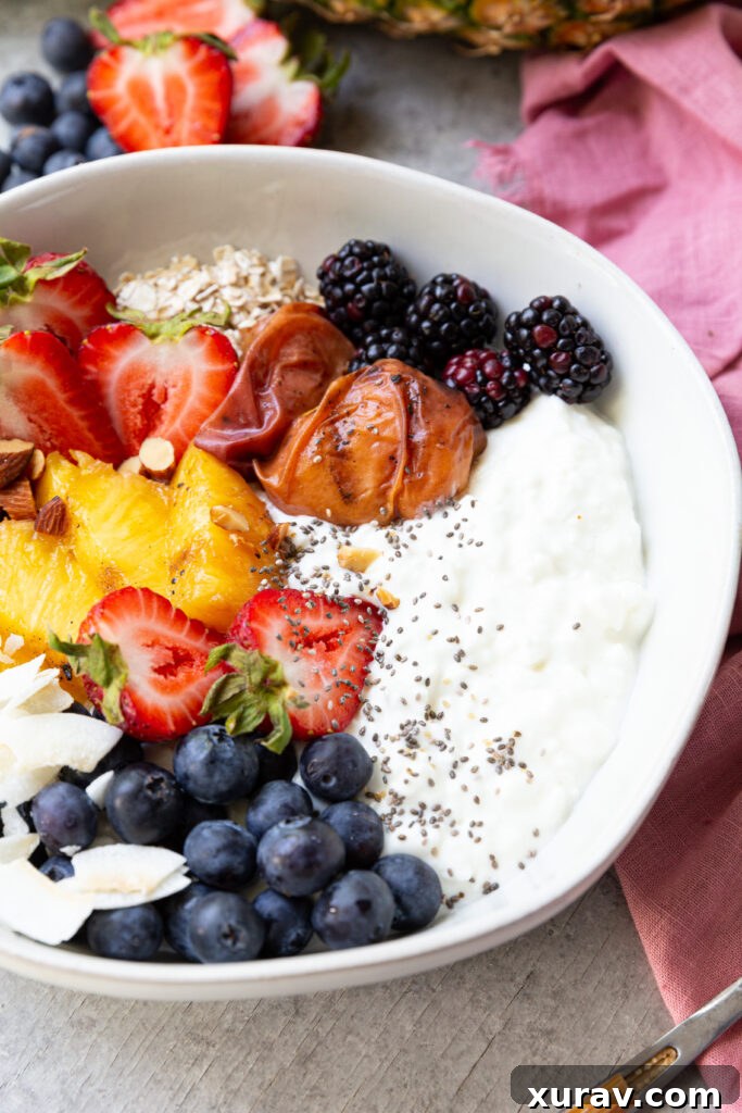 Grilled fruit, fresh berries, nuts, seeds, coconut, and cottage cheese make this high protein breakfast bowl a real treat. 