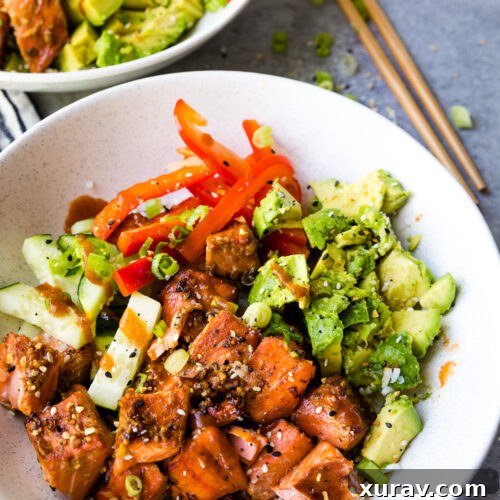 Air fryer honey sriracha salmon bites in a rice bowl with pickled vegetables