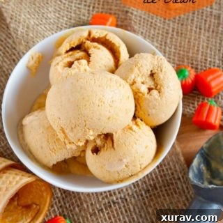 A perfectly scooped ball of pumpkin pie ice cream, ready to serve.