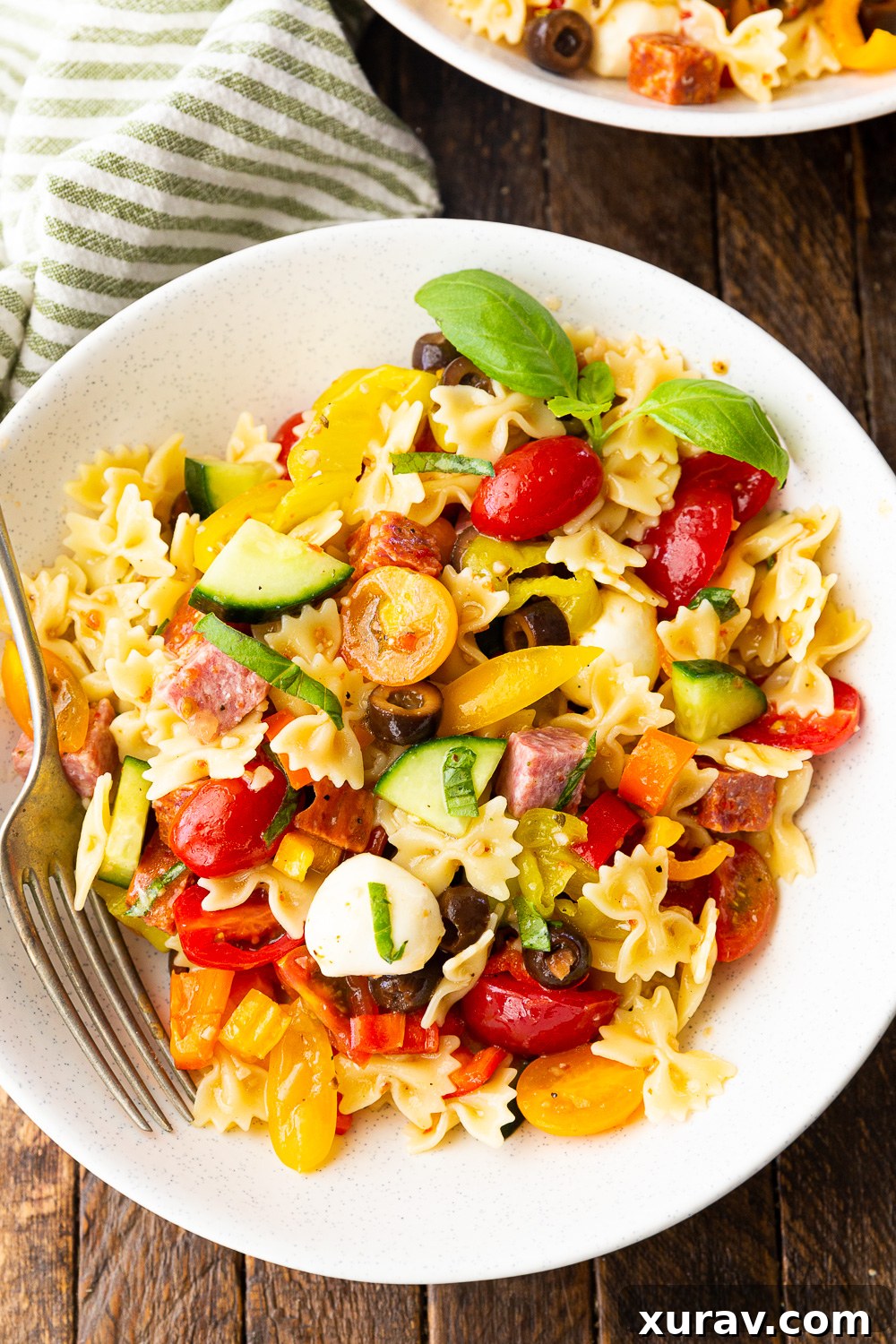 A vibrant bowl of Easy Pasta Salad, glistening with a simple 2-ingredient Italian dressing, ready to be served.