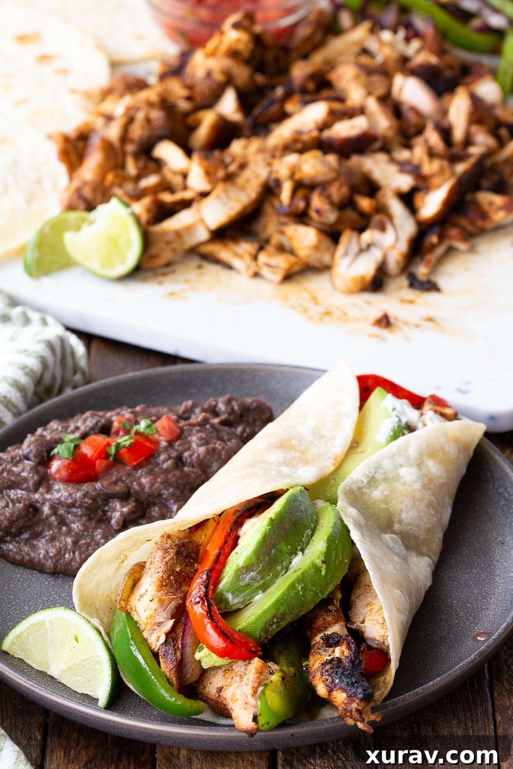 Chicken fajitas served with black beans, a complete and satisfying meal presentation.