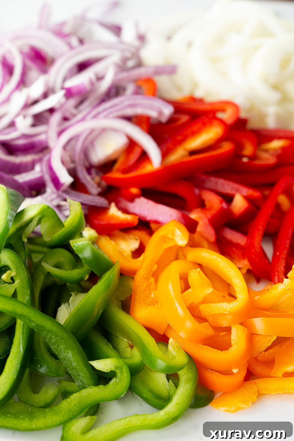 Sliced up onions and peppers for chicken fajitas, perfectly prepped for cooking.