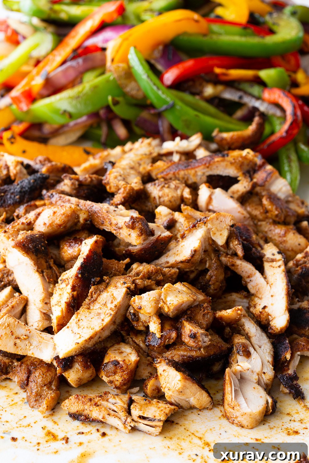 A platter of chicken fajitas, showcasing the vibrant chicken and vegetables, ready to be served.