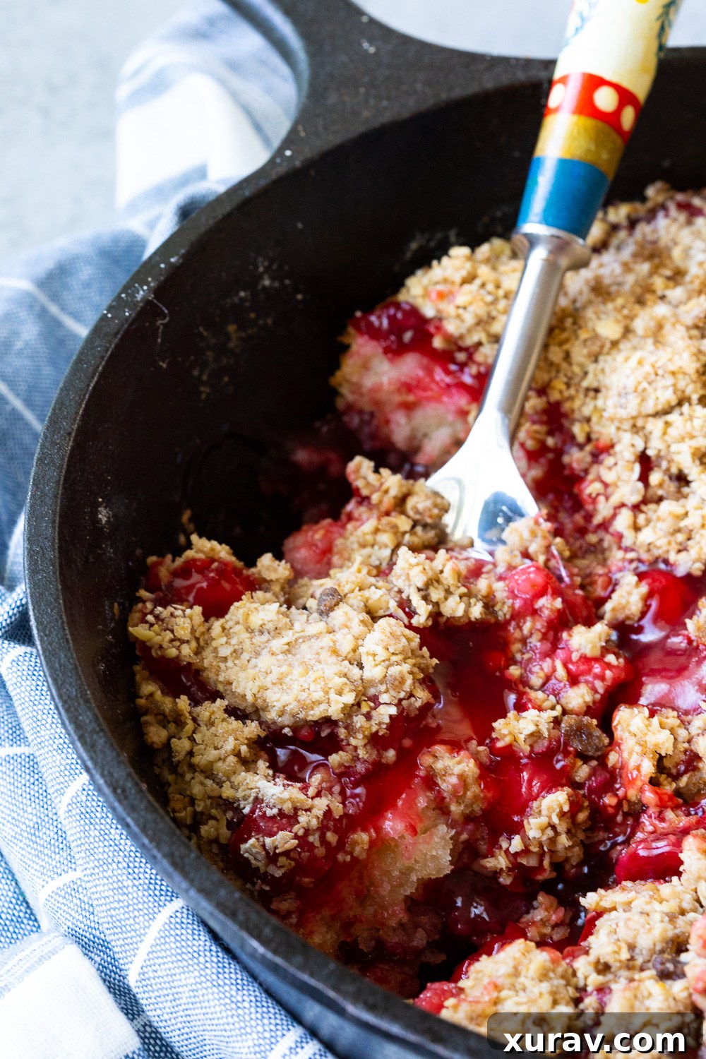 Cherry Cobbler, made in a cast iron skillet or Dutch oven, showcasing its delicious, bubbly crust and fruit filling.