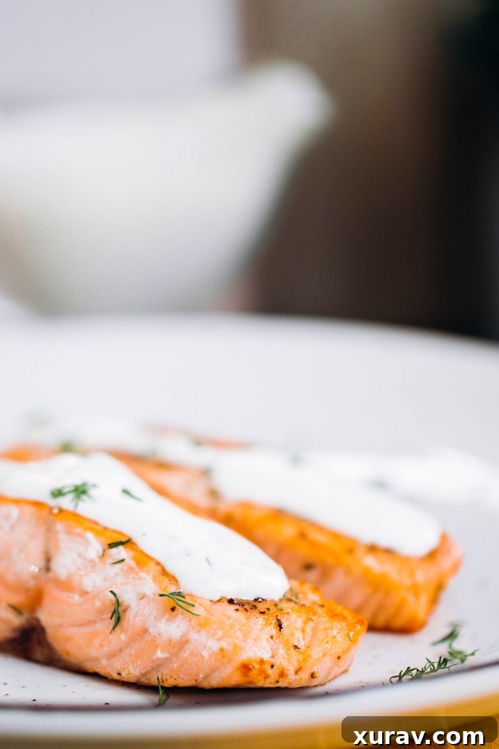 Garlic Rosemary Salmon with creamy dill sauce, ready to be enjoyed