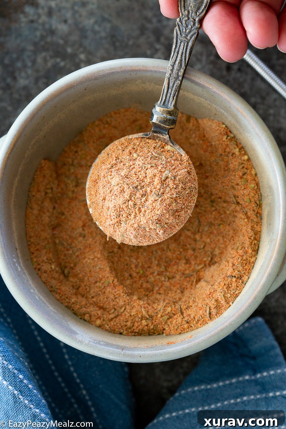 A homemade cajun seasoning blend, ready to be used in various dishes, showcasing its vibrant color and texture.