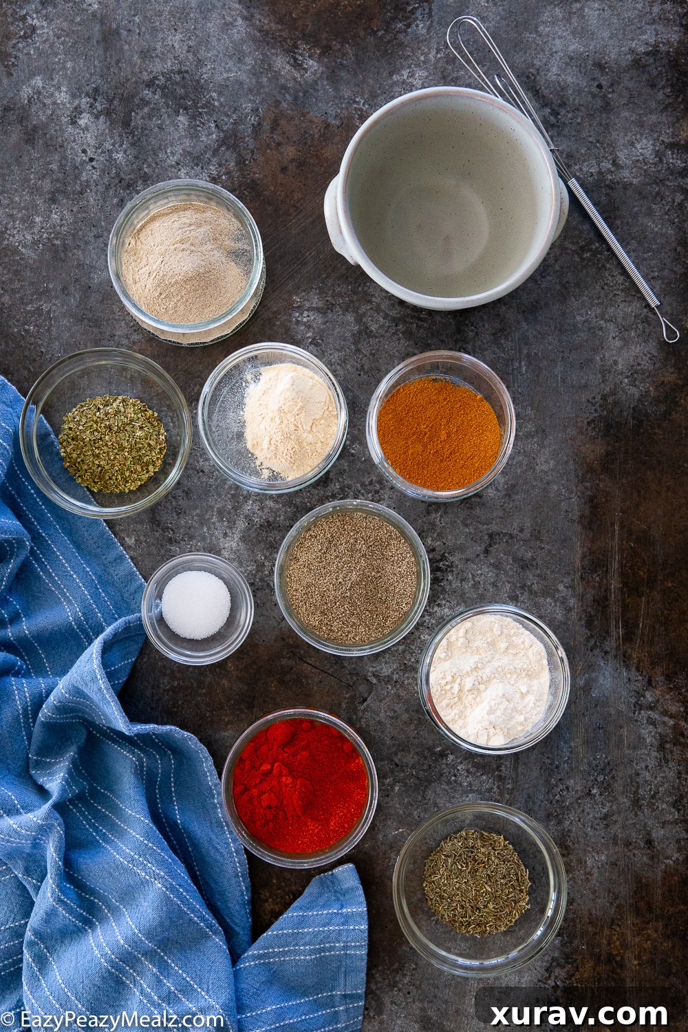 Ingredients needed to make a homemade cajun seasoning blend, laid out on a clean surface.