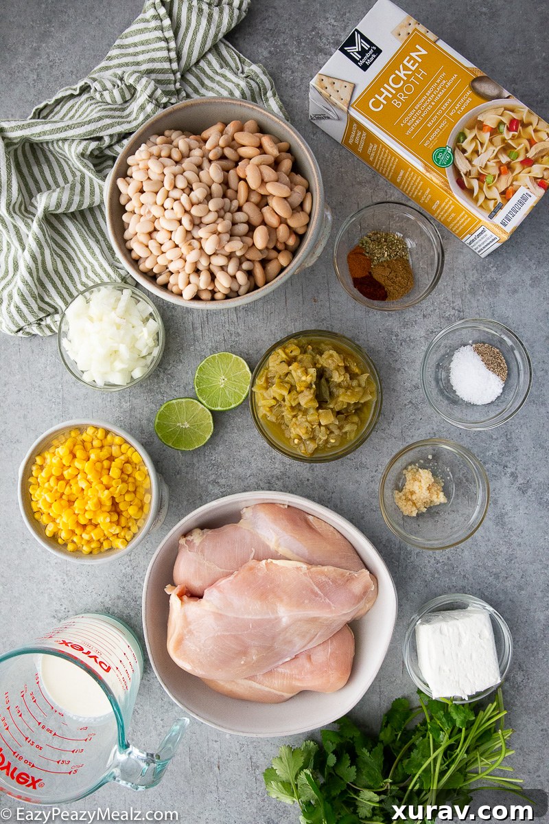 All the fresh ingredients and canned goods laid out for making white chicken chili in the slow cooker.