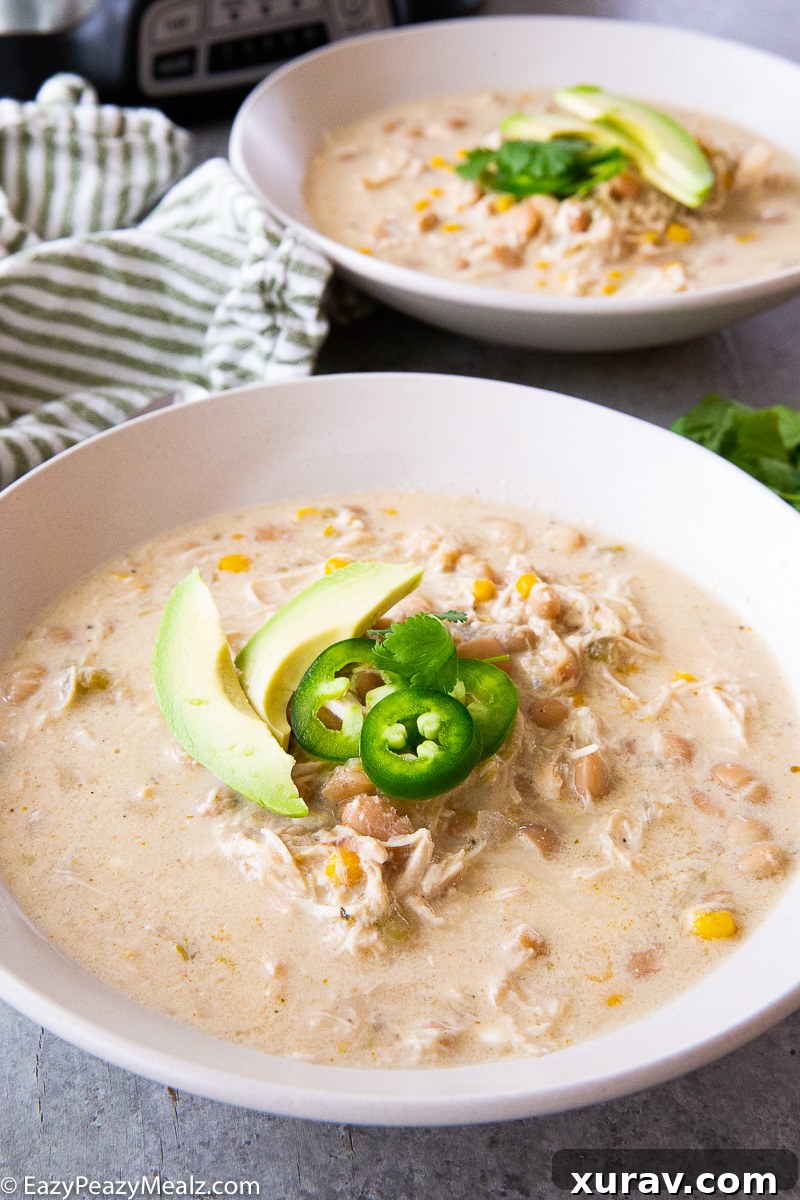 Various delicious toppings for white chicken chili, including shredded cheese, cilantro, and sour cream.