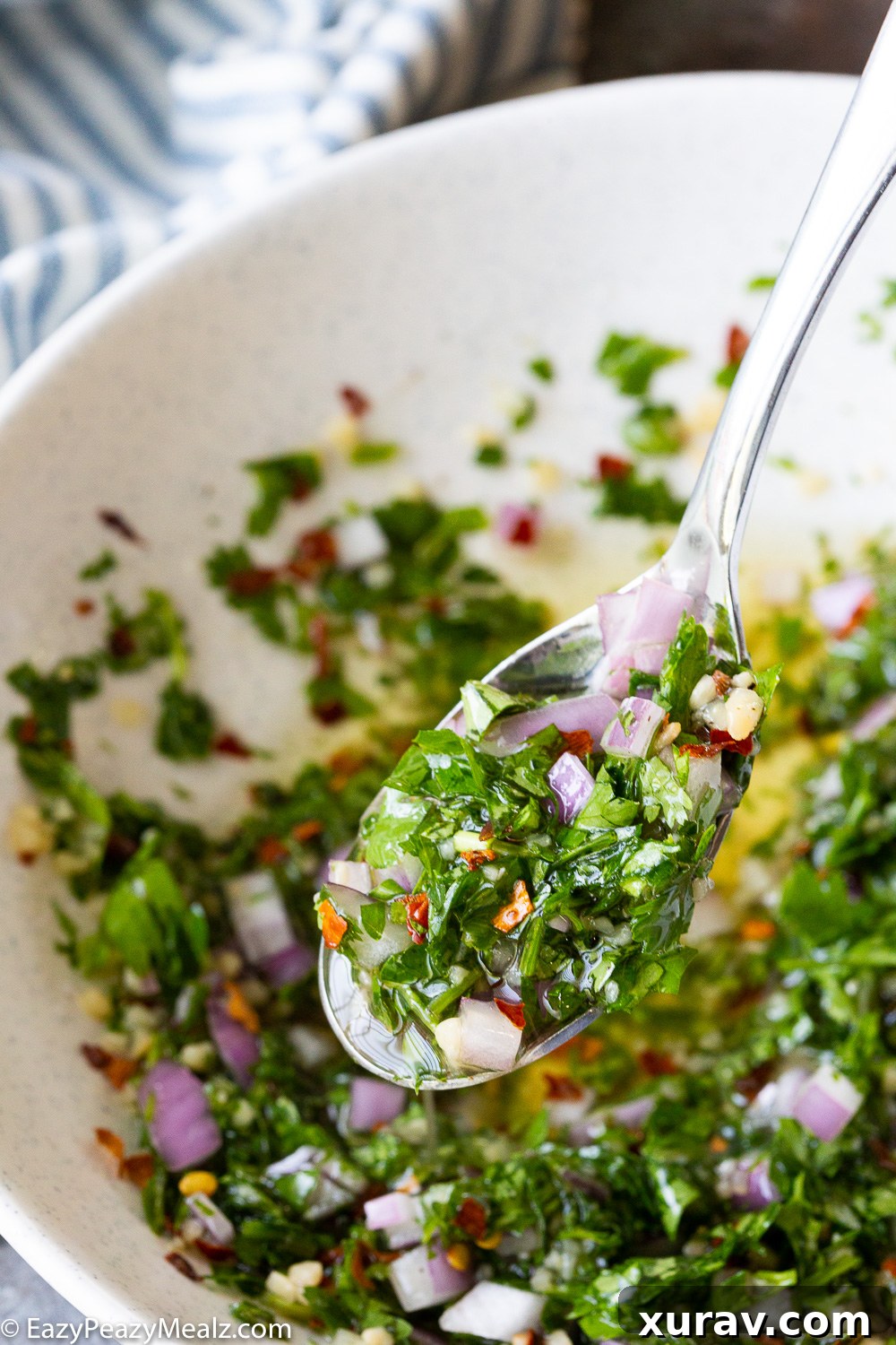 Freshly prepared chimichurri sauce in a bowl, ready to be served with grilled pork tenderloin