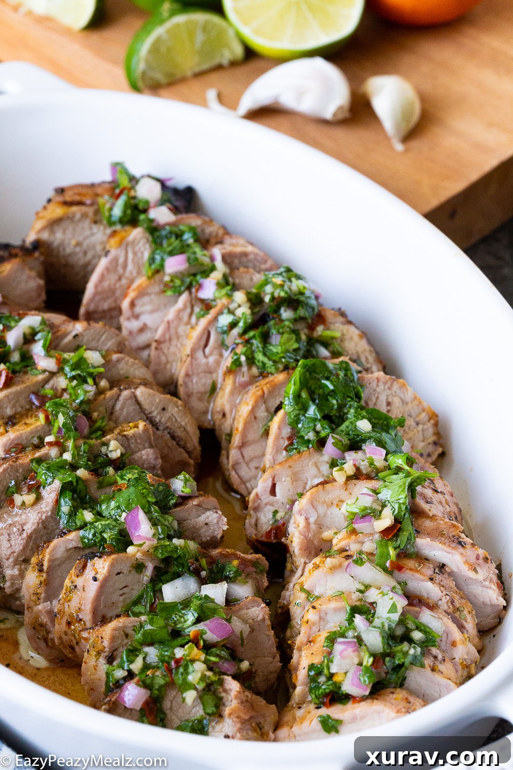 Beautifully plated citrus marinated grilled pork tenderloin with generous chimichurri on top
