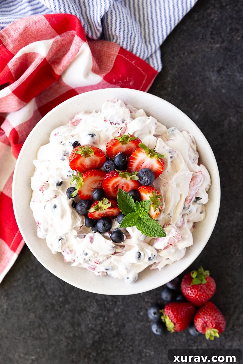 Vibrant Berry Cheesecake Salad bursting with fresh strawberries, blueberries, folded into a rich, creamy cheesecake filling—perfect for summer gatherings and potlucks.