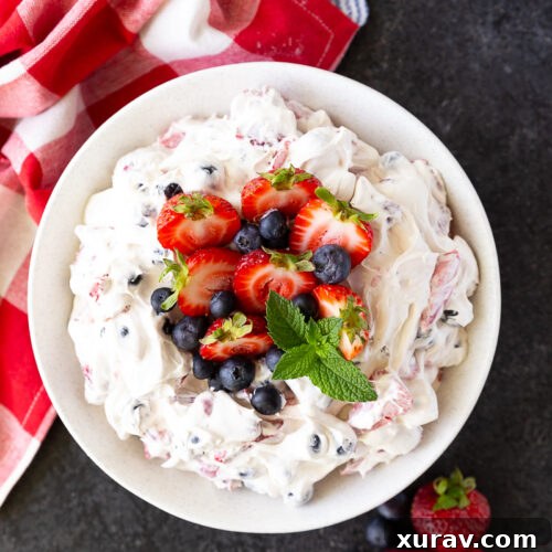 Vibrant Berry Cheesecake Salad bursting with fresh strawberries, blueberries, folded into a rich, creamy cheesecake filling—perfect for summer gatherings and potlucks.