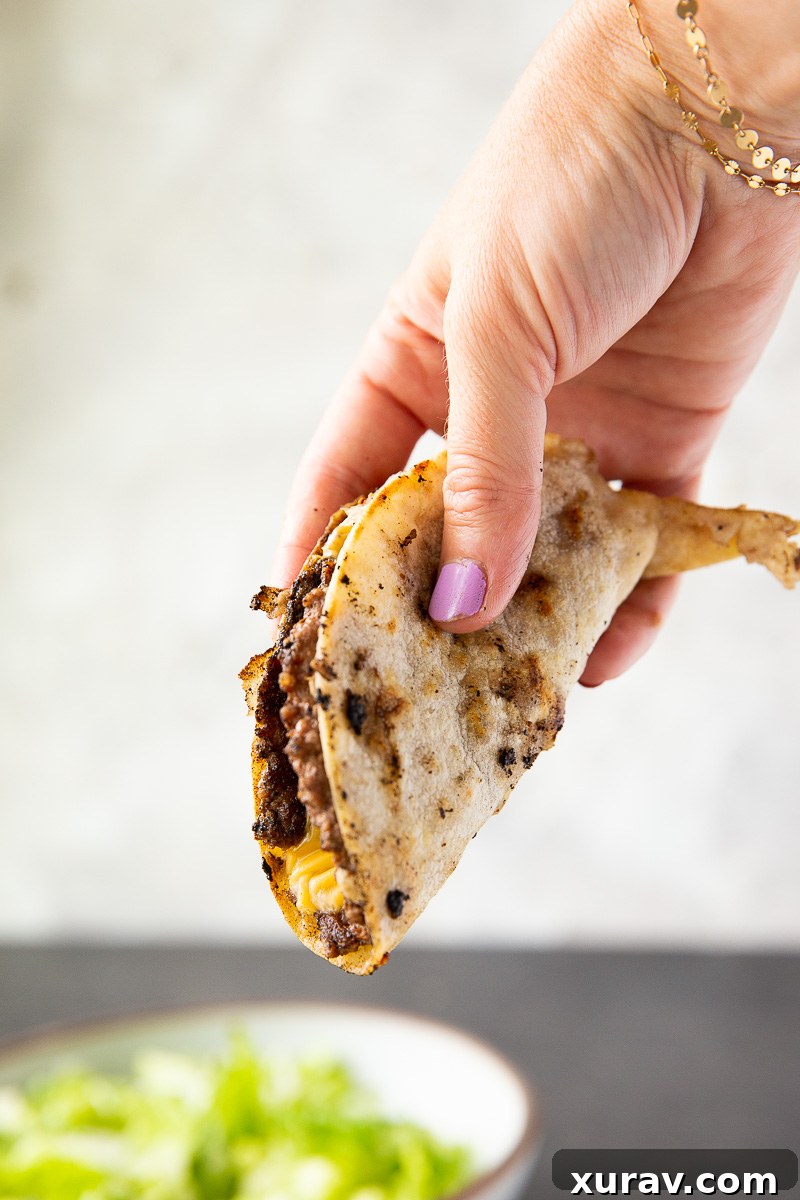 Making smashburger tacos on a griddle. 