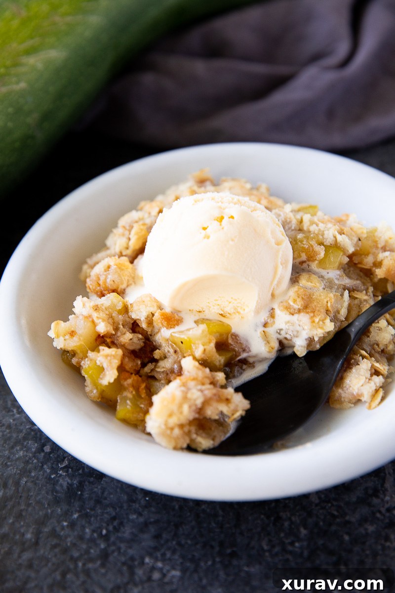 This zucchini crisp tastes just like apple crisp but uses summer zucchini instead! A sweet, cinnamon-spiced dessert with a buttery crumb topping—perfect for using up garden zucchini.