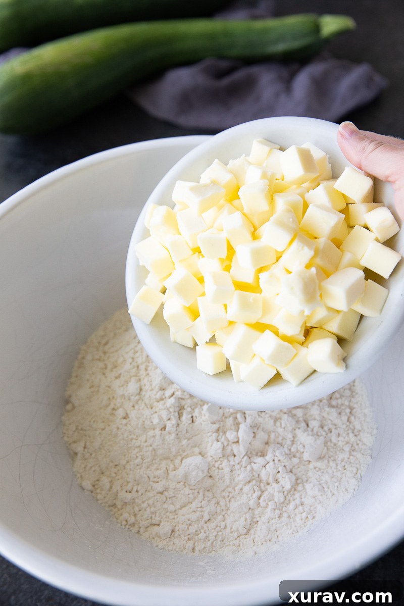 Made with diced zucchini, lemon juice, sugar, warm spices, and a buttery flour-based crumb topping, these simple ingredients come together to create a dessert that tastes just like classic apple crisp.