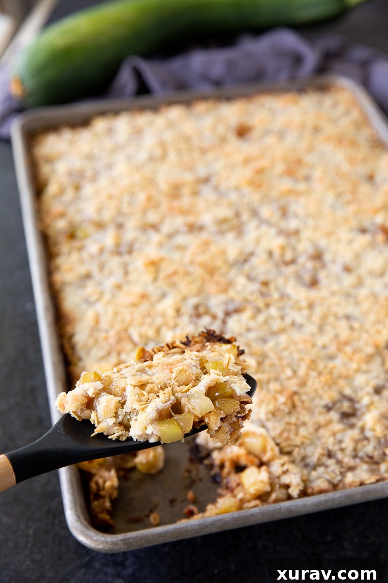 Made with diced zucchini, lemon juice, sugar, warm spices, and a buttery flour-based crumb topping, these simple ingredients come together to create a dessert that tastes just like classic apple crisp.