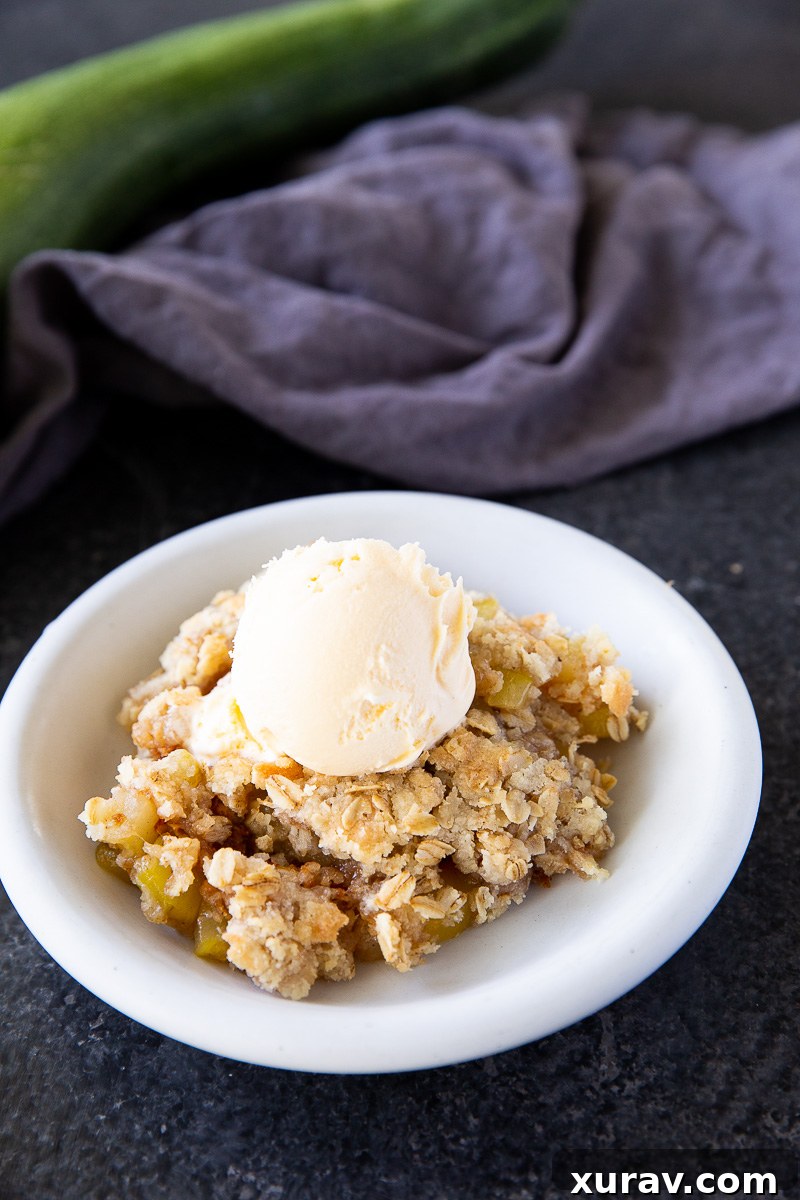 Golden and bubbly zucchini crisp fresh from the oven, with a perfectly spiced filling and a buttery crumble topping—an irresistible summer dessert that looks just like apple crisp.