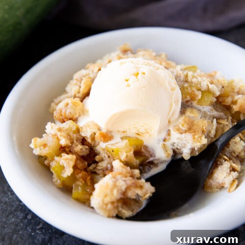 This zucchini crisp tastes just like apple crisp but uses summer zucchini instead! A sweet, cinnamon-spiced dessert with a buttery crumb topping—perfect for using up garden zucchini.