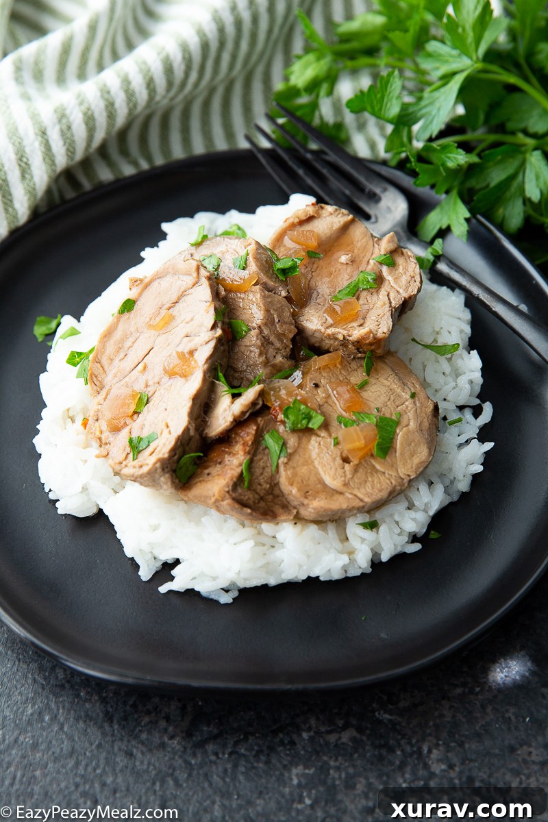 Slow cooker pork tenderloin with teriyaki sauce and pineapple slices, garnished with fresh green onions and sesame seeds.