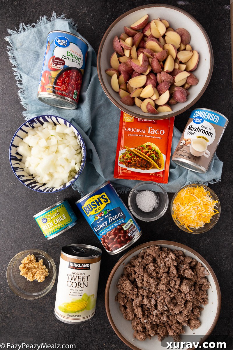 All the fresh and canned ingredients meticulously laid out for preparing Slow Cooker Cowboy Casserole.