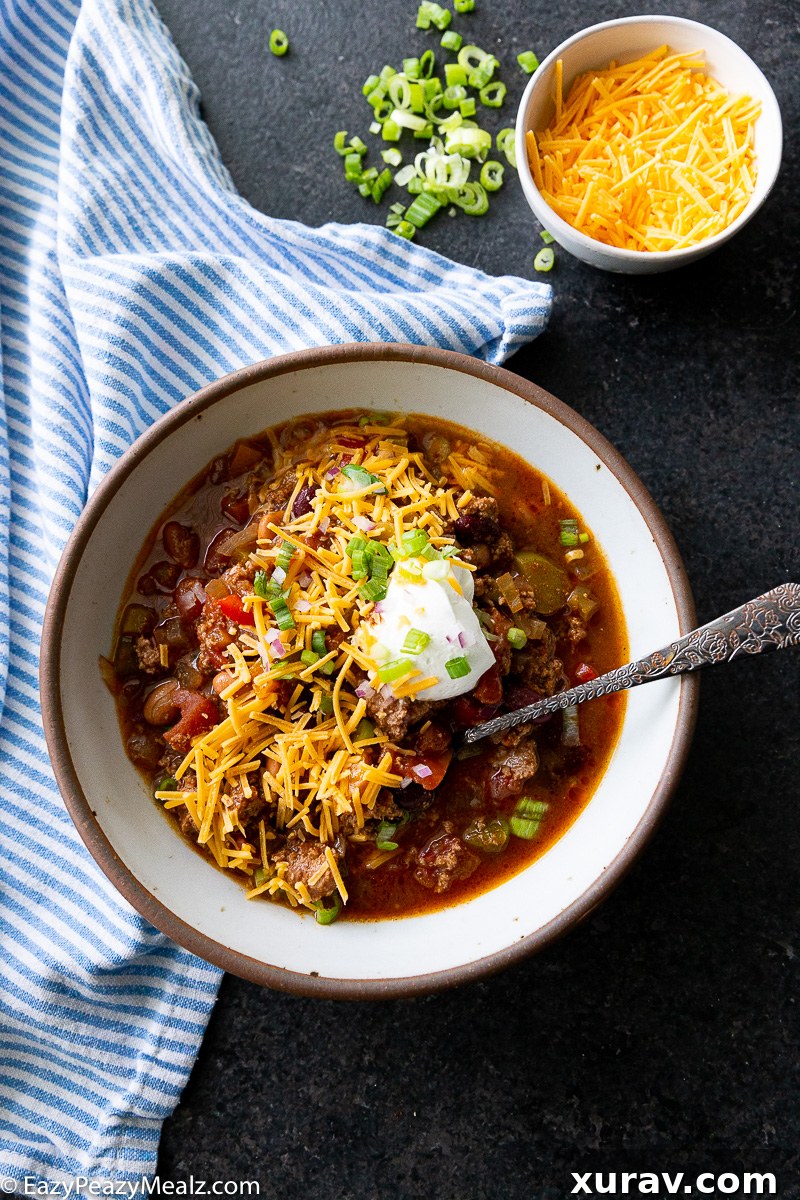 A bowl of slow cooker turkey chili is mega flavorful and so easy to make, a true dump-and-go recipe, garnished with sour cream and cilantro.