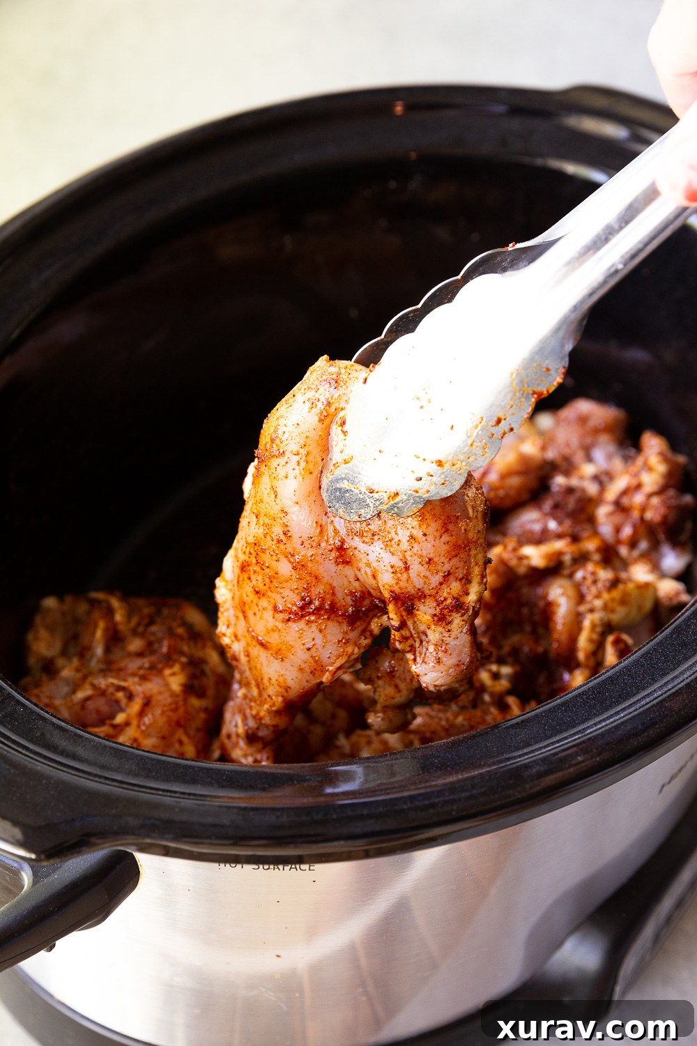 Shredded salsa verde chicken in a slow cooker