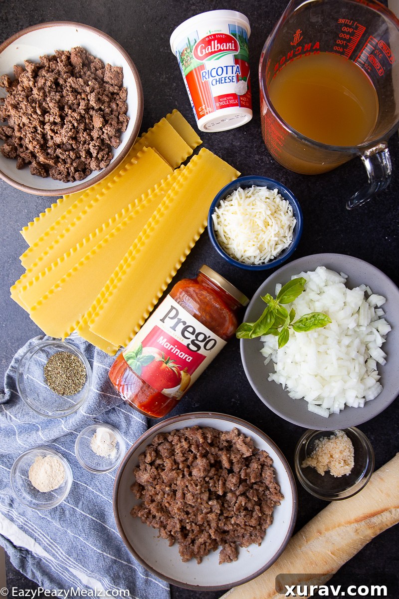 A colorful array of ingredients for Slow Cooker Lasagna Soup, including ground beef, sausage, marinara, noodles, and cheeses.