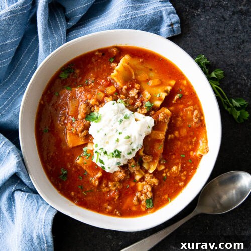 A beautifully presented bowl of Slow Cooker Lasagna Soup with ricotta and basil, alongside the full recipe card.