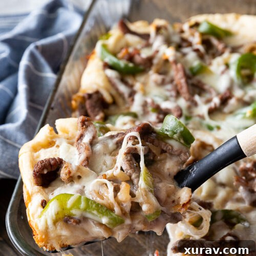 Philly Cheesesteak Bake, a delightful combo of bread, cheese, steak, peppers and onions.